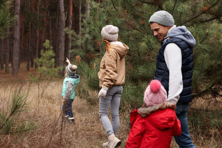 Happy family spending time together in forest