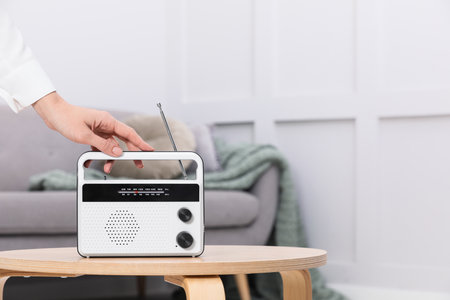 Woman with stylish white radio at home, closeup. Space for textの写真素材
