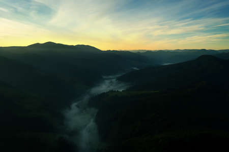 Picturesque view of foggy mountains and beautiful sky in the early morning. drone photography