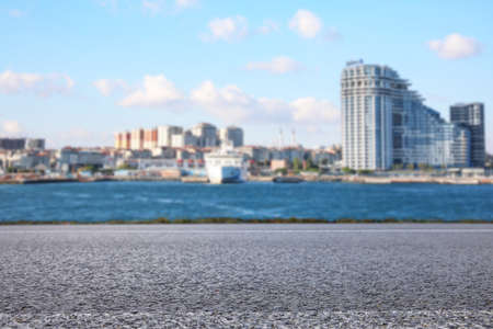 Empty road asphalt, beautiful view of cityscape and river on sunny dayの写真素材