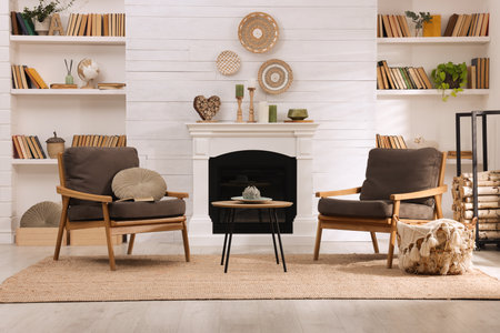 Cozy living room interior with comfortable armchairs near fireplaceの写真素材