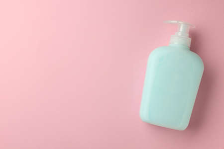 Bottle of liquid soap on pink background, top view. Space for textの写真素材