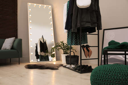 Modern dressing room interior with clothing rack and mirrorの写真素材