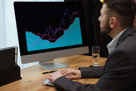 Forex trader working with computer in officeの写真素材