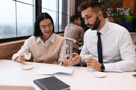 Coworkers talking in cafe during coffee break