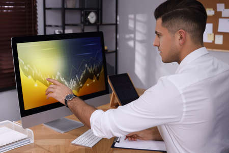 Businessman working with computer in office. Forex trading