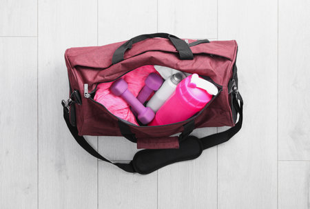 Sports bag with gym stuff on white floor, top viewの写真素材