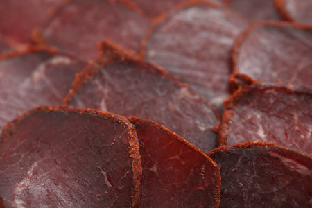 Delicious dry-cured beef basturma slices as background, closeupの写真素材