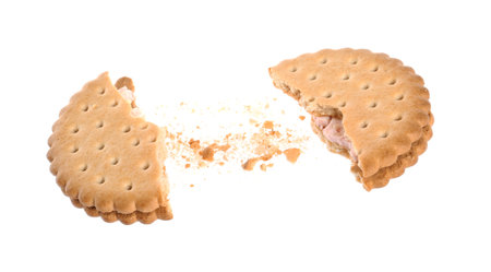 Broken tasty sandwich cookie with cream on white backgroundの写真素材