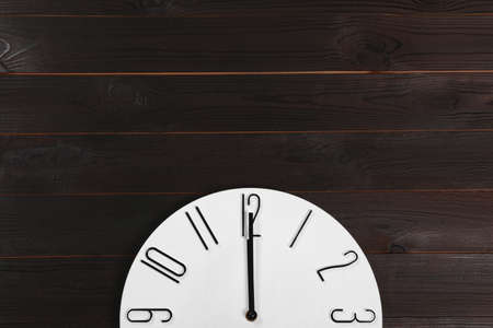 Stylish analog clock hanging on wooden wall, space for textの写真素材