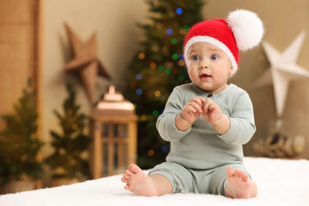 Cute little baby in the room decorated for Christmas. Winter holidayの写真素材