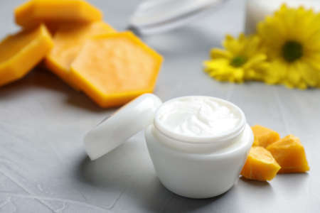 Cream with natural beeswax component on light gray stone table, closeupの写真素材