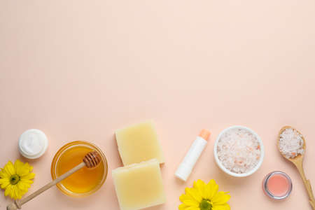 Flat lay composition with beeswax and cosmetic products on beige background. Space for textの写真素材