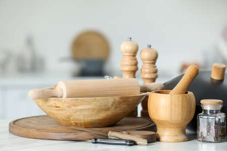 Set of cooking utensils on white table against blurred backgroundの写真素材