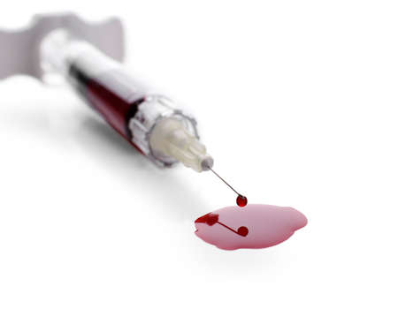 Plastic syringe with blood on white backgroundの写真素材