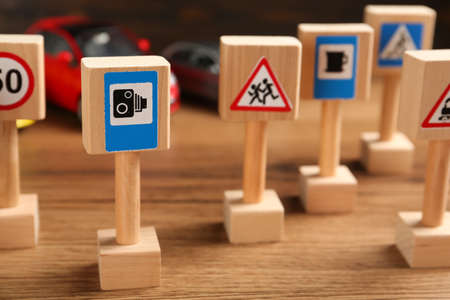 Many different miniature road signs on wooden table, closeup. driving schoolの写真素材