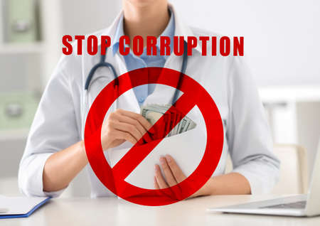 Stop corruption. Illustration of red prohibition sign and doctor with bribe at desk in clinic, closeupの写真素材