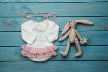 Flat lay composition with cute baby knitwear for photoshoot on light blue wooden backgroundの写真素材