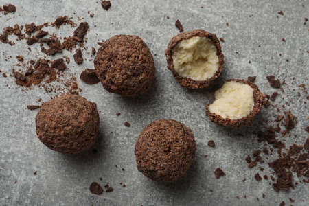 Many delicious chocolate truffles on gray table, flat layの写真素材
