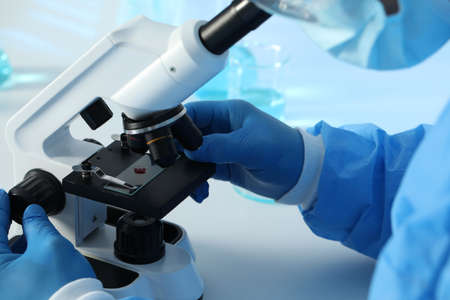 Scientist working with microscope at table, closeup. medical research