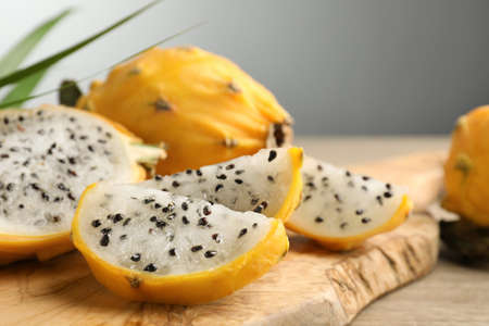 Delicious cut dragon fruit (pitahaya) on wooden board, closeup. Space for textの写真素材