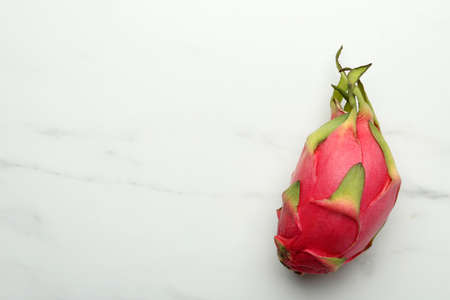 Delicious pitahaya fruit on white marble table, top view. Space for textの写真素材