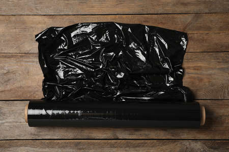 Roll of plastic stretch wrap film on wooden table, top viewの写真素材