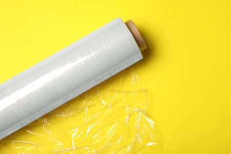 Roll of plastic stretch wrap film on yellow background, top viewの写真素材