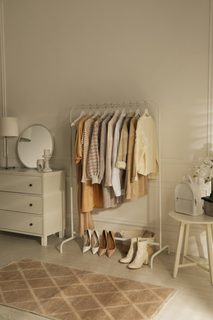 Modern dressing room interior with stylish clothes, shoes and white backpackの写真素材