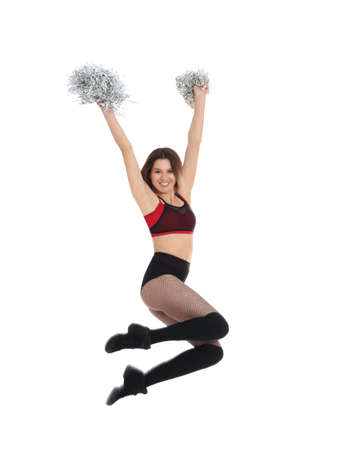 Beautiful cheerleader with pom poms jumping on white backgroundの写真素材