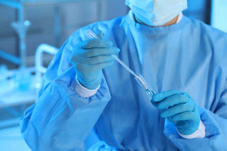 Scientist dripping sample into test tube in laboratory, closeup. Medical researchの写真素材