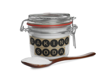 Spoon and jar with baking soda on white backgroundの写真素材