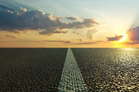 View of empty asphalt road at sunset