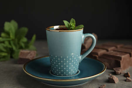 Cup of delicious hot chocolate with fresh mint on gray tableの写真素材