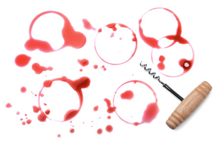 Red wine rings with drops and corkscrew on white background, top viewの写真素材