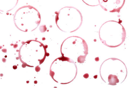 Red wine rings and drops on white background, top viewの写真素材