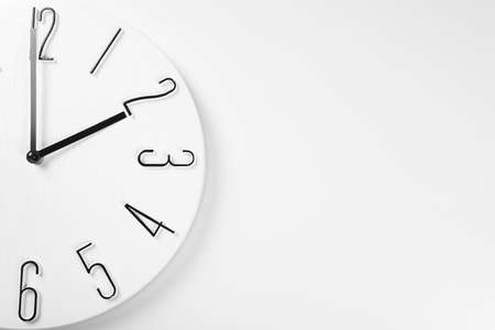 Stylish analog clock hanging on white wall, space for textの写真素材