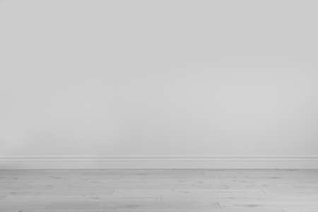 Empty white wall and wooden floor in room
