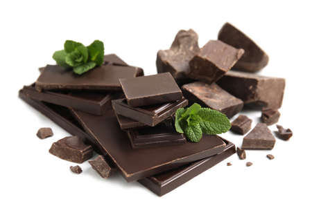 Tasty dark chocolate pieces with mint on white backgroundの写真素材