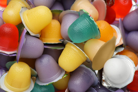 Tasty bright jelly cups as background, top viewの写真素材