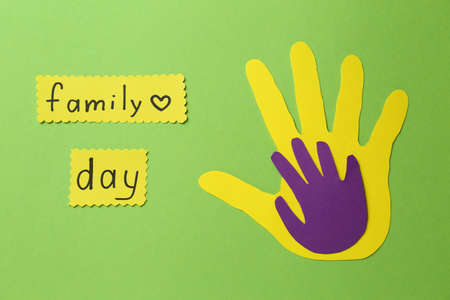Paper palms and cards with text Family Day on light green background, flat layの写真素材