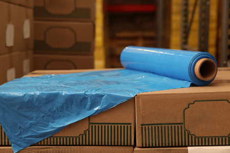 Roll of stretch wrap on boxes in warehouseの写真素材