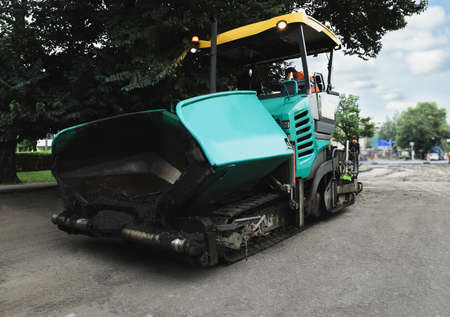 Modern asphalt finisher on city street. road repair service