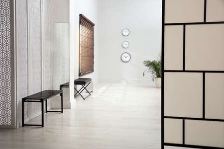 Empty office corridor with benches and window