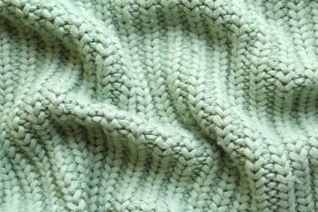 Beautiful pale green knitted fabric as background, top viewの写真素材