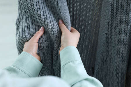 Woman touching clothes made of soft knitted fabric, closeupの写真素材