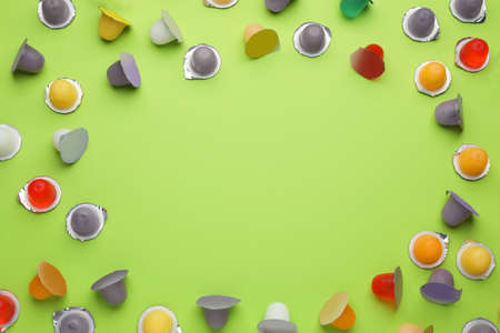 Frame of tasty bright jelly cups on green background, flat lay. Space for textの写真素材