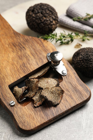 Fresh black truffles and slicer on gray table, closeupの写真素材