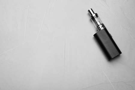 Electronic cigarette on gray table, top view with space for text. smoking alternativeの写真素材