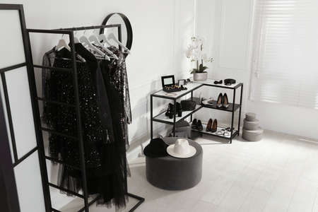 Stylish dressing room interior with trendy clothes, shoes and accessoriesの写真素材